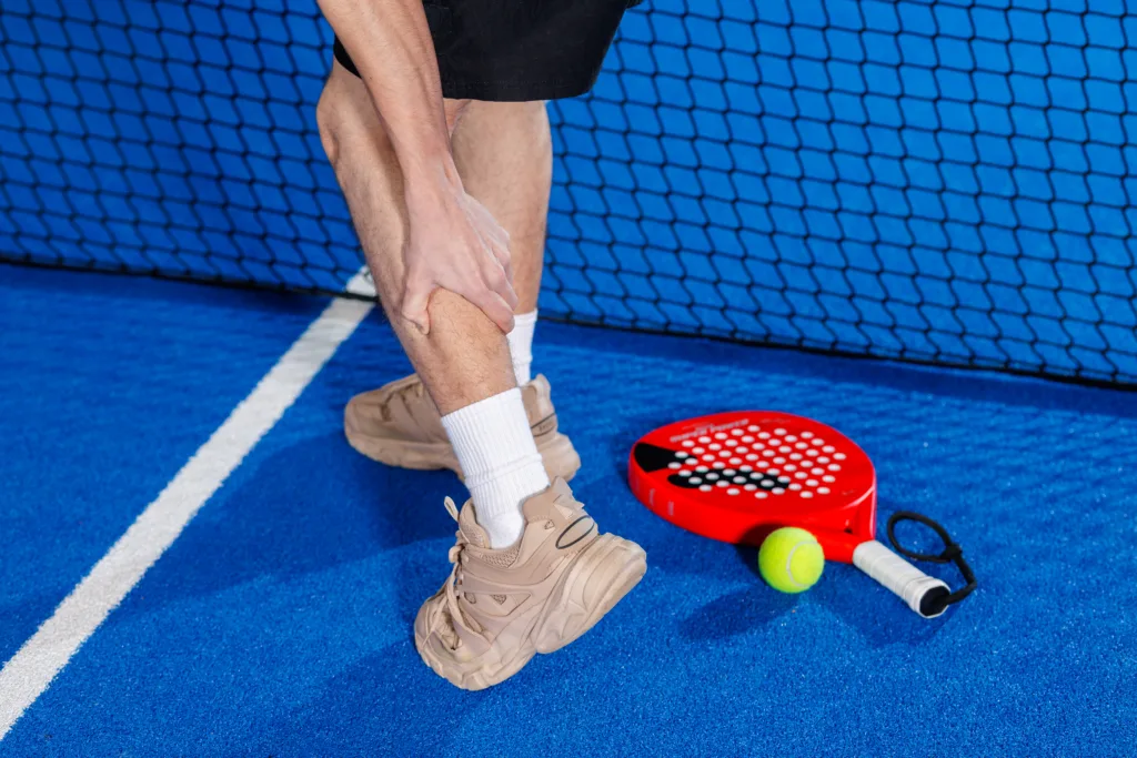 padel player holding calf pain during indoor match 2026 03 27 00 54 07 utc (1)
