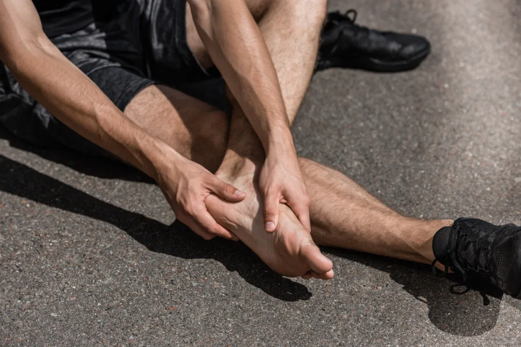 partial view of barefoot sportsman with foot pain 2026 03 13 01 21 31 utc